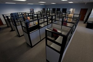 Workers assemble new furniture in a new office.